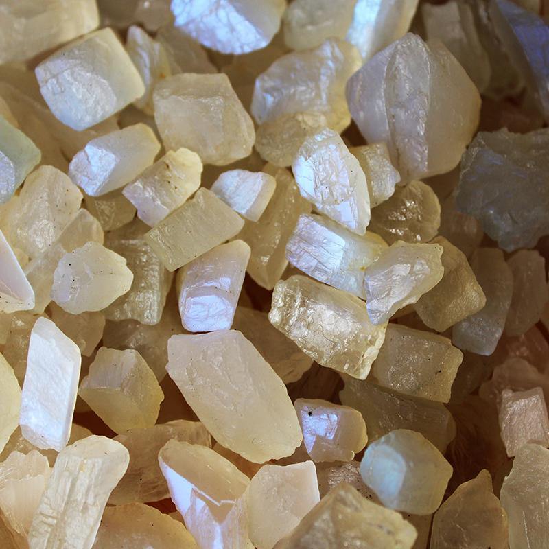 Close-up of raw crystal stones with a beige background