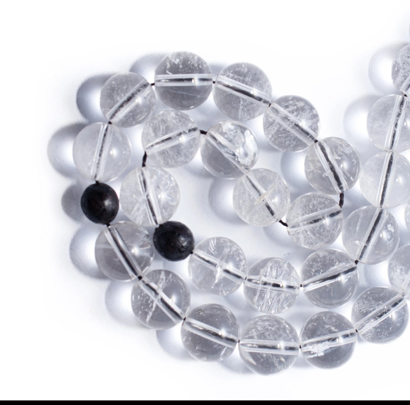 Crystal Quartz 100 beads 8mm with black ebony wood tassel.
     